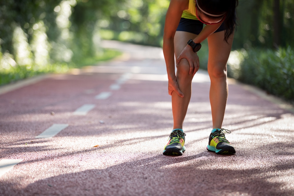 Female runner suffering from leg injury