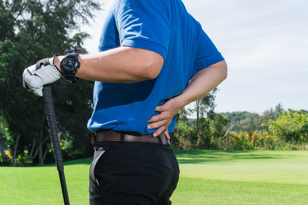 Male golfer suffering from back pain